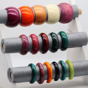 Umiwi Armreif. Handgefertig aus 100% Mangoholz in verschiedenen Farben. Umweltfreundlich gefärbt mit Lebensmittelfarbe, erhältlich in 3 Breiten und 2 Größen. Einzigartig, leicht und nachhaltig – unter fairen Bedingungen in Thailand gefertigt